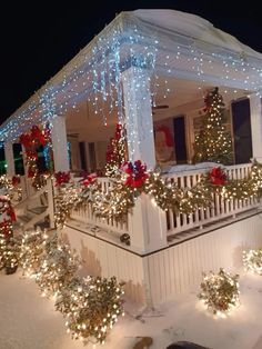 a house covered in christmas lights and garlands