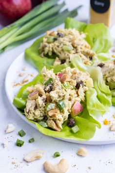 two lettuce wraps filled with chicken salad and garnished with almonds