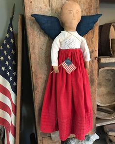 a doll is hanging on the wall in a room with an american flag and other items