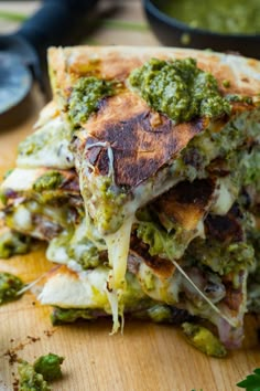 a close up of a pizza with broccoli and cheese on the crusts