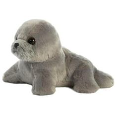 a stuffed seal animal laying on the ground