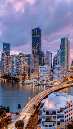 the city skyline is lit up at night