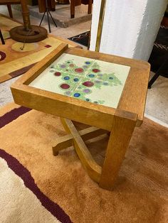 a wooden table sitting on top of a carpeted floor next to a chair and rug