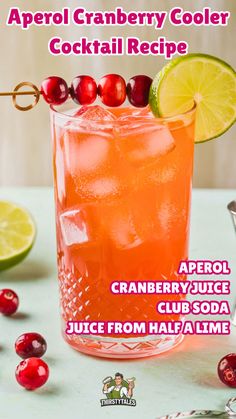 a cranberry cooler cocktail recipe in a glass garnished with cherries and lime