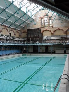 an empty swimming pool in a large building