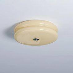 a white ceiling light on a gray wall