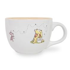 a winnie the pooh coffee cup on a white background