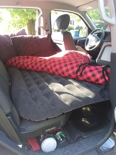 an inflatable bed is placed inside the back of a car's trunk