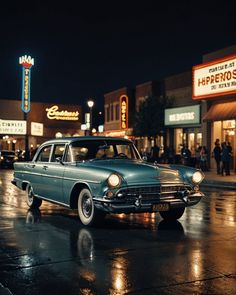 an old car is parked on the street in front of some stores at night time