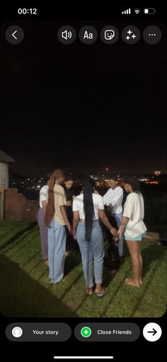 several people standing in the grass at night