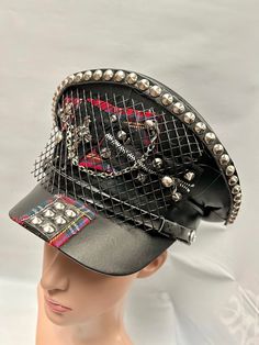 This is a black leatherette captain hat. Well made to a high standard. It has plenty of eye catching detail including metal studs, safety pins , please refer to photos . This is a size 59 cm which fits most size heads. No two hats are created the same. Individual and unique  Thank you for looking Black Alternative Style Hats For Alternative Fashion, Black Punk Hat For Cosplay, Black Punk Costume Hats And Headpieces, Punk Black Mini Hat For Cosplay, Punk Style Black Mini Hat For Cosplay, Punk Brimmed Hats For Cosplay, Black High Crown Costume Hat For Festival, Adjustable Punk Visor Hat, Adjustable Punk Mini Hat For Cosplay