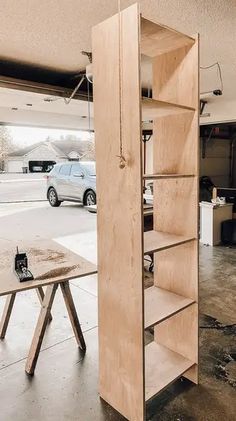 an open book shelf in the middle of a garage