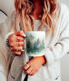 a woman holding a coffee mug in her hands