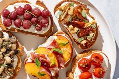 a white plate topped with bread covered in fruit and veggies