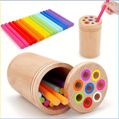 a wooden box filled with lots of colorful crayons next to a cup full of colored pencils