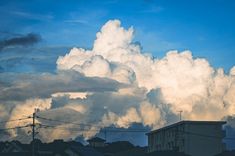 the sky is filled with clouds and houses