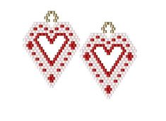 two red and white christmas ornaments hanging from strings on a white background with the word love spelled