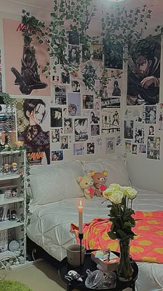 a bedroom with many pictures on the wall and a bed in front of it,