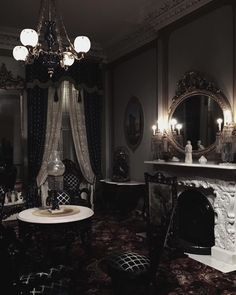 an ornately decorated living room with chandelier, fireplace and mirror on the wall