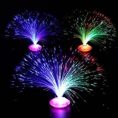 three colorful fireworks are lit up in the dark