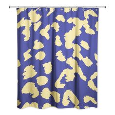 a blue and yellow shower curtain with an animal print on the bottom, in front of a white background