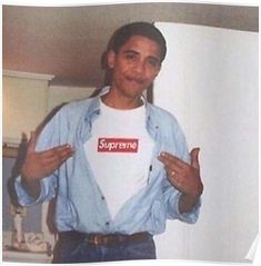 a man wearing a supreme t - shirt standing in front of a white refrigerator freezer