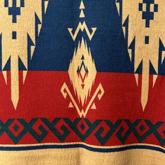 a red, white and blue blanket with designs on it