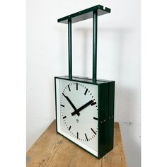 a clock sitting on top of a wooden table