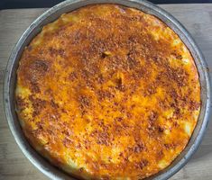 a cheese pizza sitting on top of a metal pan