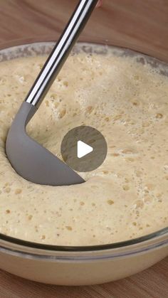 a bowl filled with batter on top of a wooden table