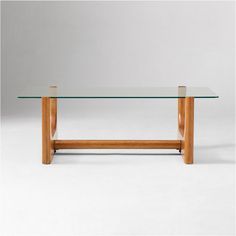 a glass table with wooden legs on a white background