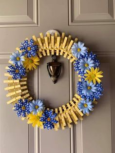 a yellow and blue wreath hanging on the front door