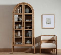 a wooden book case sitting next to a chair