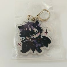 a keychain with an anime character on it's front and back sides