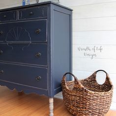 a blue dresser and basket in a room