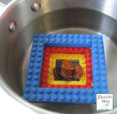 a metal bowl with some legos in it