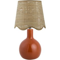 an orange table lamp with a beige shade on the base and a brown fabric lampshade