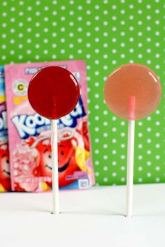 two candy lollipops sitting next to each other on top of a table