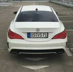 the back end of a white mercedes benz s - class coupe parked in a parking lot