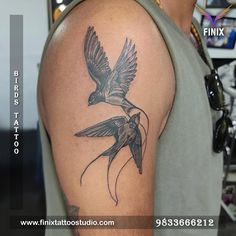 a man with a bird tattoo on his arm