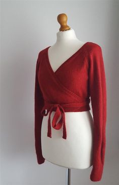 a white mannequin with a red sweater on it