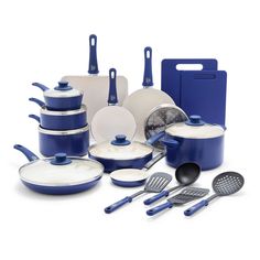 a blue and white cookware set is shown with utensils, pans, and spatulas