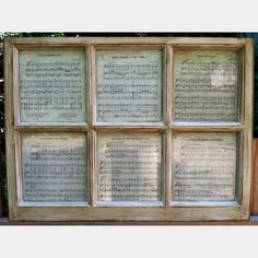 an old window with sheet music on it