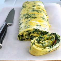 an omelet with spinach and cheese is cut in half