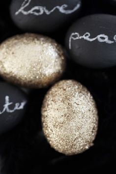 some black and white rocks with gold glitter paint on them that say peace, peace