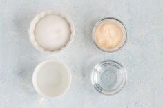 three bowls with different types of food in them on a blue table top next to each other