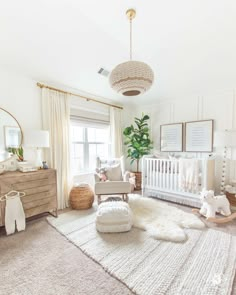 a baby's room with white furniture and decor