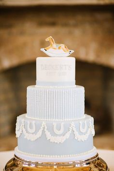 a wedding cake sitting on top of a table next to a gold plated object