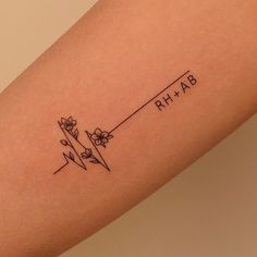 a woman's arm with flowers on it and the word phi hab written in black ink