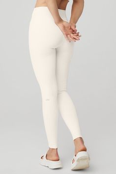 An on-trend high waistline on our classic Airbrush legging. Spotted on basically every it-girl, the High-Waist Airbrush Legging has an on-trend rise and all the best assets of the classic version, like no side seams and a yogi-tested fit that lifts and sculpts. Sculpts, smooths & lifts! No side seams & flat-locked seams for extra comfort Designed & uniquely fit to flatter every size Wear-tested by our in-house team for the perfect fit High-Waist Airbrush Legging in Ivory, Size: Medium | Alo Yoga Ivory Leggings, Cream Leggings, Liquid Leggings, Tank Top Bras, White Leggings, Black Flare, Faux Leather Leggings, It Girl, Alo Yoga